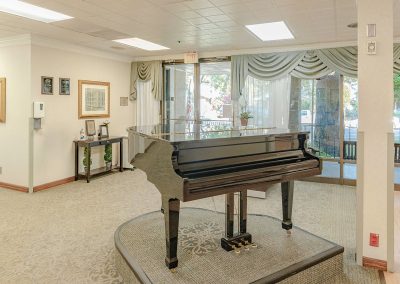 A parlor grand piano at the Woodland Nursing and Rehab facility