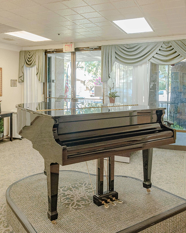 A parlor grand piano at the Woodland Nursing and Rehab facility